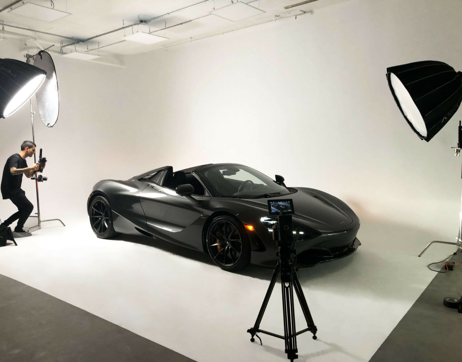 McLaren Video Shoot man shooting car staged on cyc wall